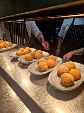 Chefs plating crispy croquettes during a tapas course at a Chesil Rectory wine dinner in Winchester