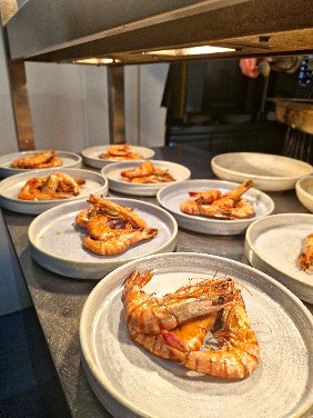 Plated gambas prawns prepared for a tapas course at a Chesil Rectory wine dinner in Winchester